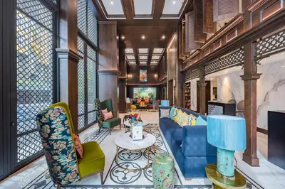 a living room with a blue couch and chairs at The Base Central Phuket-B20W in Ban Rangeng