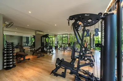 a gym with several treadmills and exercise bikes at C179 Serene and Stylish Getaway in Kamala, Phuket in Kamala Beach