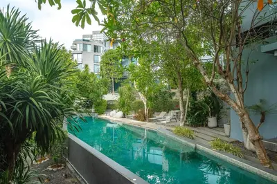 a swimming pool with trees and a building at C179 Serene and Stylish Getaway in Kamala, Phuket in Kamala Beach