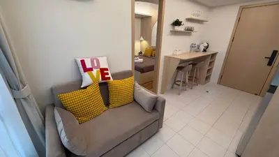 a living room with a couch and a table at Fantasea Kamala Beach 1 BR 313 in Kamala Beach
