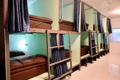 a row of bunk beds in a room at The City Hostel in Phi Phi Don