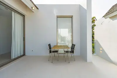 a dining room with a table and chairs on a balcony at V183 Lux Pride Villas 3BR Private Pool Retreat in Bang Tao Beach