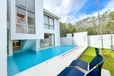 a swimming pool in the backyard of a house at Designer 3BR Pool Villa in New Build LuxPride 4 L8 Residence in Bang Tao Beach