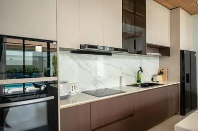a kitchen with a sink and a counter top at Mouana Breeze Maikhao VIP 4-bedroom Pool Villa 9916 in Mai Khao Beach
