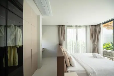 a bedroom with a bed and a window at Mouana Breeze Maikhao VIP 4-bedroom Pool Villa 9916 in Mai Khao Beach