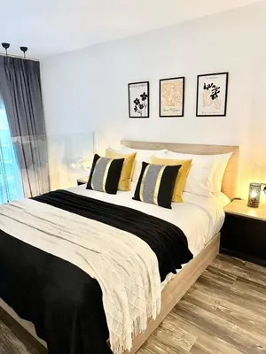 a bedroom with a large bed with yellow and black pillows at C181 Stylish 1BR Loft Near Naiharn Beach Pool Gym in Rawai Beach