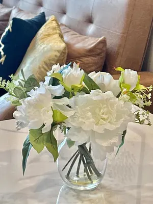 a glass vase filled with white flowers on a table at C181 Stylish 1BR Loft Near Naiharn Beach Pool Gym in Rawai Beach