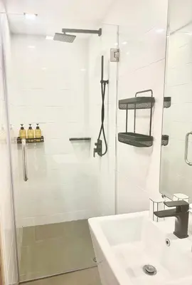 a white bathroom with a shower and a sink at C181 Stylish 1BR Loft Near Naiharn Beach Pool Gym in Rawai Beach