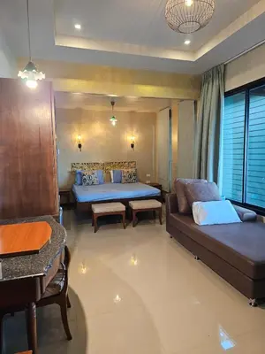 a living room with two beds and a couch at The house on the hill in Ban Na Kok