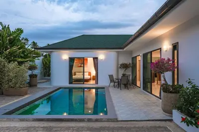 a villa with a swimming pool in front of a house at V193 Next-Door Villas 6BR 2 Pools For Group Vibe! in Rawai Beach