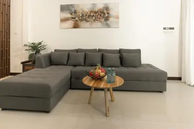 a living room with a couch and a table at Green Garden Villa Hotel in Nai Harn Beach