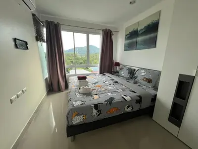 a bedroom with a bed with animals on it at Plus 1 Condo 202-67 in Kathu
