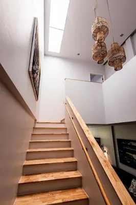 a staircase in a building with two chandeliers at ORIGINAL DESIGNED 2BR TownHouse6 MonkeyHill in Ban Sam Kong