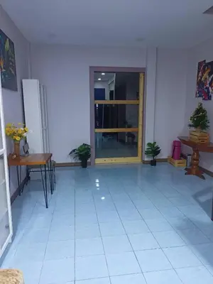 a room with a yellow door and a white tile floor at 9 Home Phuket in Ban Rangeng