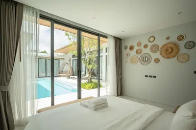a bedroom with a bed and a large window at Mouana Breeze Maikhao 3-bedroom Pool Villa 9917 in Mai Khao Beach
