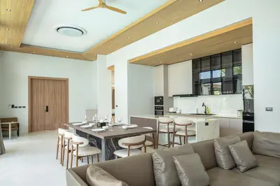 a living room with a couch and a table at Mouana Breeze Mai Khao 4-bedroom Pool Villa 9925 in Mai Khao Beach