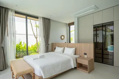 a bedroom with a white bed and a large window at Mouana Breeze Mai Khao 4-bedroom Pool Villa 9925 in Mai Khao Beach
