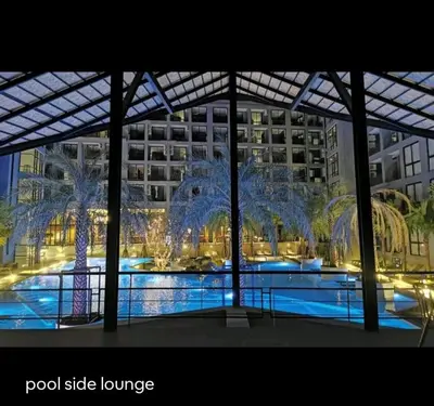 a view of a large building with a pool side lounge at City Gate Apartments Kamala Beach Phuket Thailand - LMY in Kamala Beach
