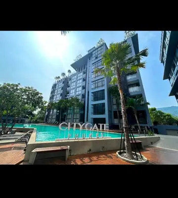 a large building with a palm tree in front of it at City Gate Apartments Kamala Beach Phuket Thailand - LMY in Kamala Beach