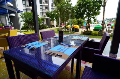 a table in a restaurant with purple chairs at Lux 2Bdr Cassia Laguna With Own Large Terrace in Laguna Phuket