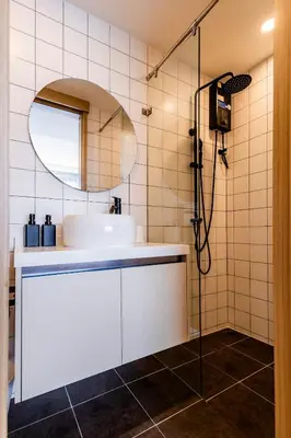 a bathroom with a sink and a mirror at Kamala Modern 2 bedroom Apartment in Kamala Beach
