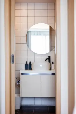 a bathroom with a sink and a mirror at Kamala Modern 2 bedroom Apartment in Kamala Beach