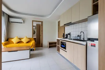 a kitchen with a yellow bed in a room at Kamala Modern 2 bedroom Apartment in Kamala Beach