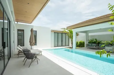 a swimming pool in a villa with a patio at Mouana Breeze Mai Khao 4-bedroom Pool Villa 9920 in Mai Khao Beach