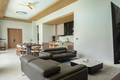 a living room with a couch and a table at Mouana Breeze Mai Khao 4-bedroom Pool Villa 9920 in Mai Khao Beach