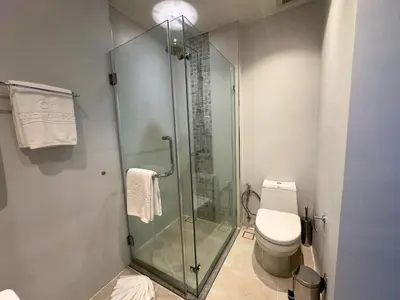 a bathroom with a glass shower and a toilet at Apartment Diamond Resort BangTao in Bang Tao Beach
