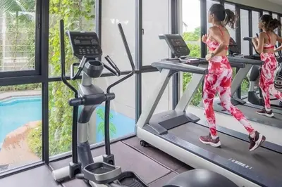 a group of women running on treadmills in a gym at Apartment Diamond Resort BangTao in Bang Tao Beach