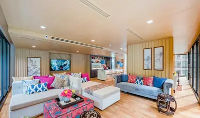 a living room with two couches and a table at The Base Central Phuket-B42WL in Ban Rangeng