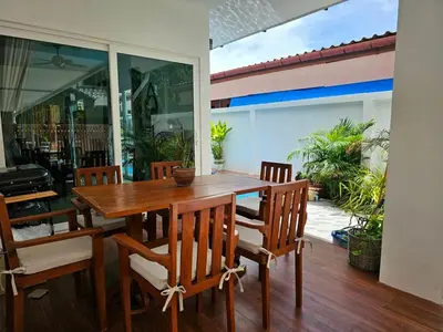 a dining room with a wooden table and chairs at Cozy 3 Bedrooms Pool Villa near Nai Harn Beach in Rawai Beach