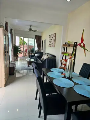 a dining room and living room with a table and chairs at Cozy 3 Bedrooms Pool Villa near Nai Harn Beach in Rawai Beach