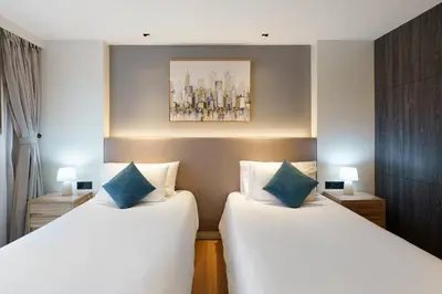two beds sitting next to each other in a room at Perfect Studio 3 pools Nai Harn in Rawai Beach