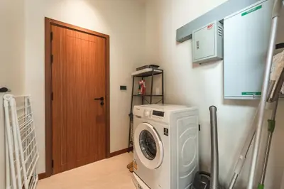 a washer and dryer in a room with a door at V186 Quiet Glamour Oasis 4BR Poolside Sanctuary in Bang Tao Beach