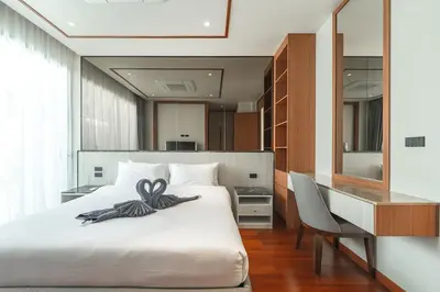 a bedroom with a bed with a bow on it at V186 Quiet Glamour Oasis 4BR Poolside Sanctuary in Bang Tao Beach