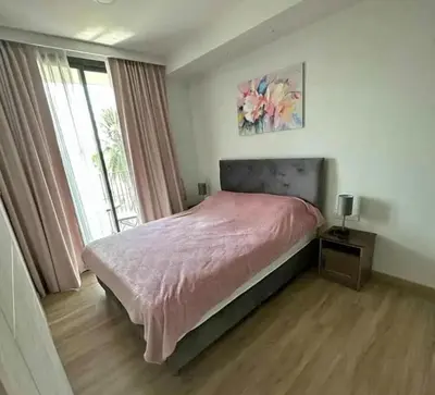 a bedroom with a bed and a large window at Аппартаменты Sky Park Laguna Phuket in Bang Tao Beach
