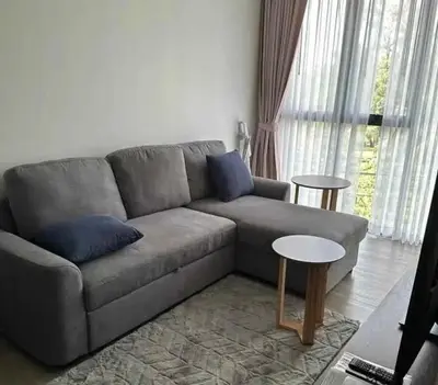 a living room with a couch and a table at Аппартаменты Sky Park Laguna Phuket in Bang Tao Beach
