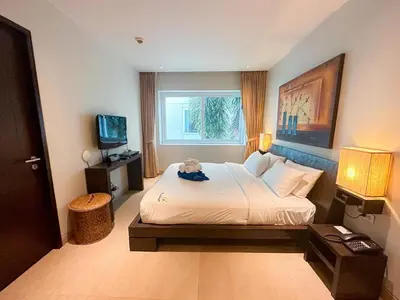 a hotel room with a bed with a teddy bear on it at NEW Malee Resort Studio 858 in Rawai Beach