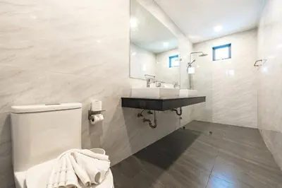 a white bathroom with a toilet and a sink at V189 Stylish 3BR Hideaway Pool & Beach Vibes in Rawai Beach