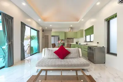 a living room with a couch with a red pillow at V189 Stylish 3BR Hideaway Pool & Beach Vibes in Rawai Beach