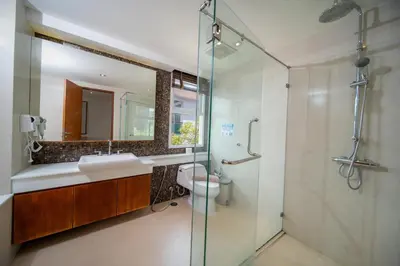 a bathroom with a toilet and a sink and a shower at Patong private spacious apart-ment 2 minutes walk to the beach bathtub sea view swimming pool in Patong Beach