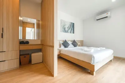 a bedroom with a large bed and a mirror at V190 Tropical Oasis 3BR Villa with Pool & Bathtub in Rawai Beach