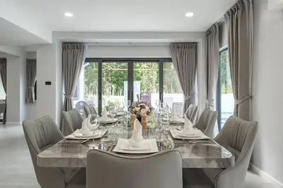 a dining room with a long table and chairs at V192 Brand New Golf side 5BR Villa with Private Pool in Kathu