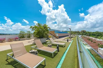 a row of lounge chairs on the roof of a building at C189 Beachside Luxury in Rawai Sea View and Gym in Rawai Beach
