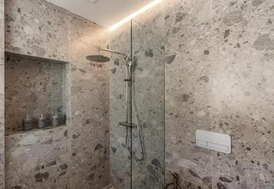 a bathroom with a shower with a glass door at Sunshine Beach Residence Resort in Phuket Town