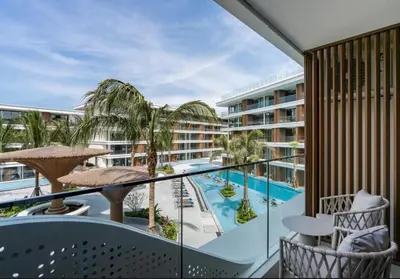 a balcony with a swimming pool and a resort at Sunshine Beach Residence Resort in Phuket Town