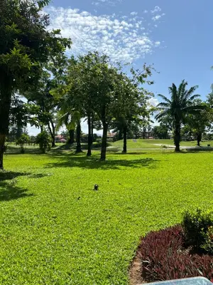 a park with trees and a field of green grass at Allamanda 3 Laguna Phuket by Star in Laguna Phuket