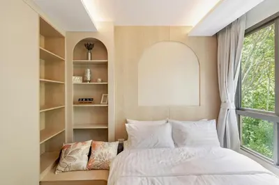 a bedroom with a bed and a window at Cozy New 1-Bedroom Apartment with Pool, 5 Min Walk to Kamala Beach in Kamala Beach